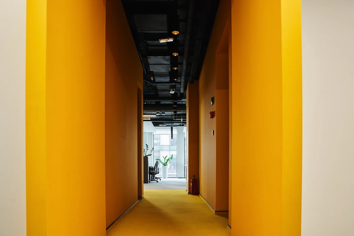 Office corridor with bright yellow painted walls