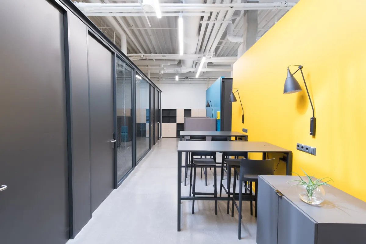 Office workspace with a yellow accent wall